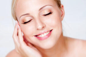 Blonde woman with glowing skin enjoys her smooth complexion after microneedling with PRP